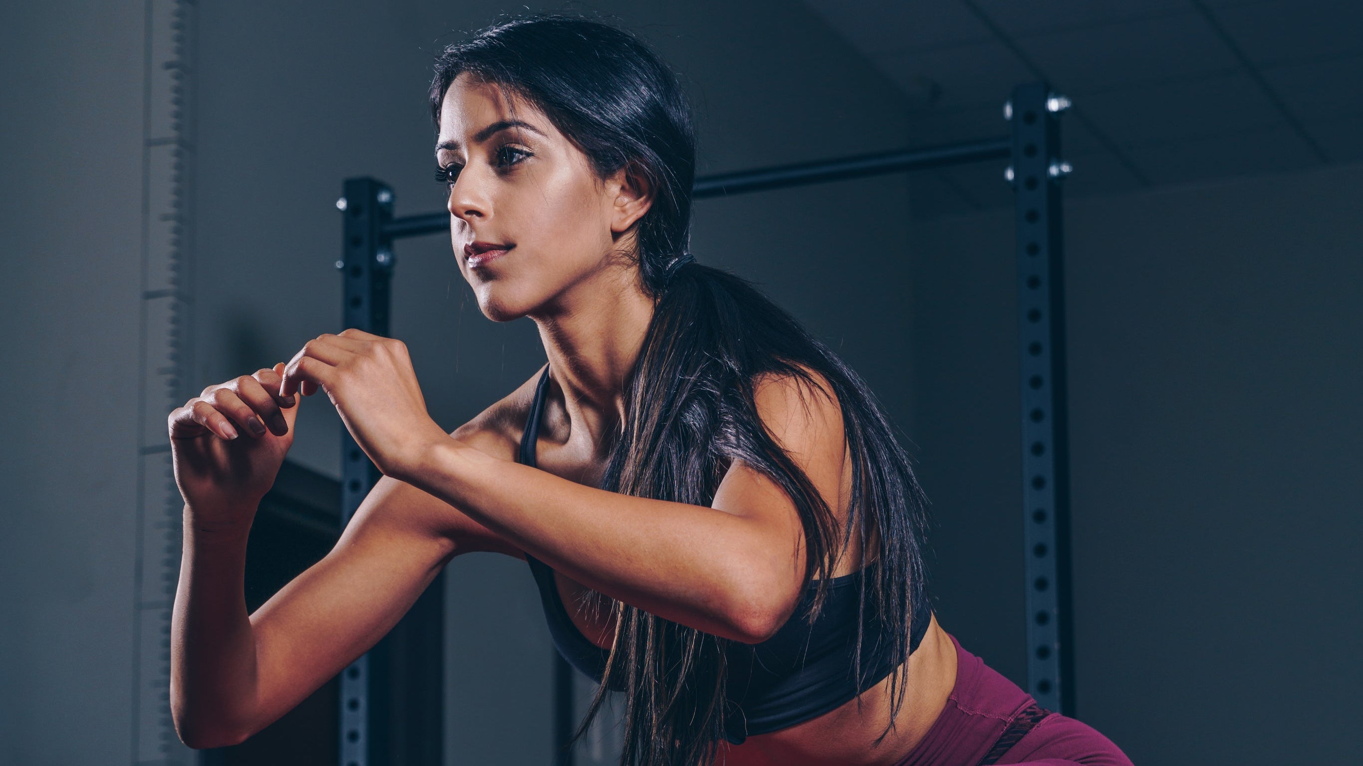 woman squatting on mat